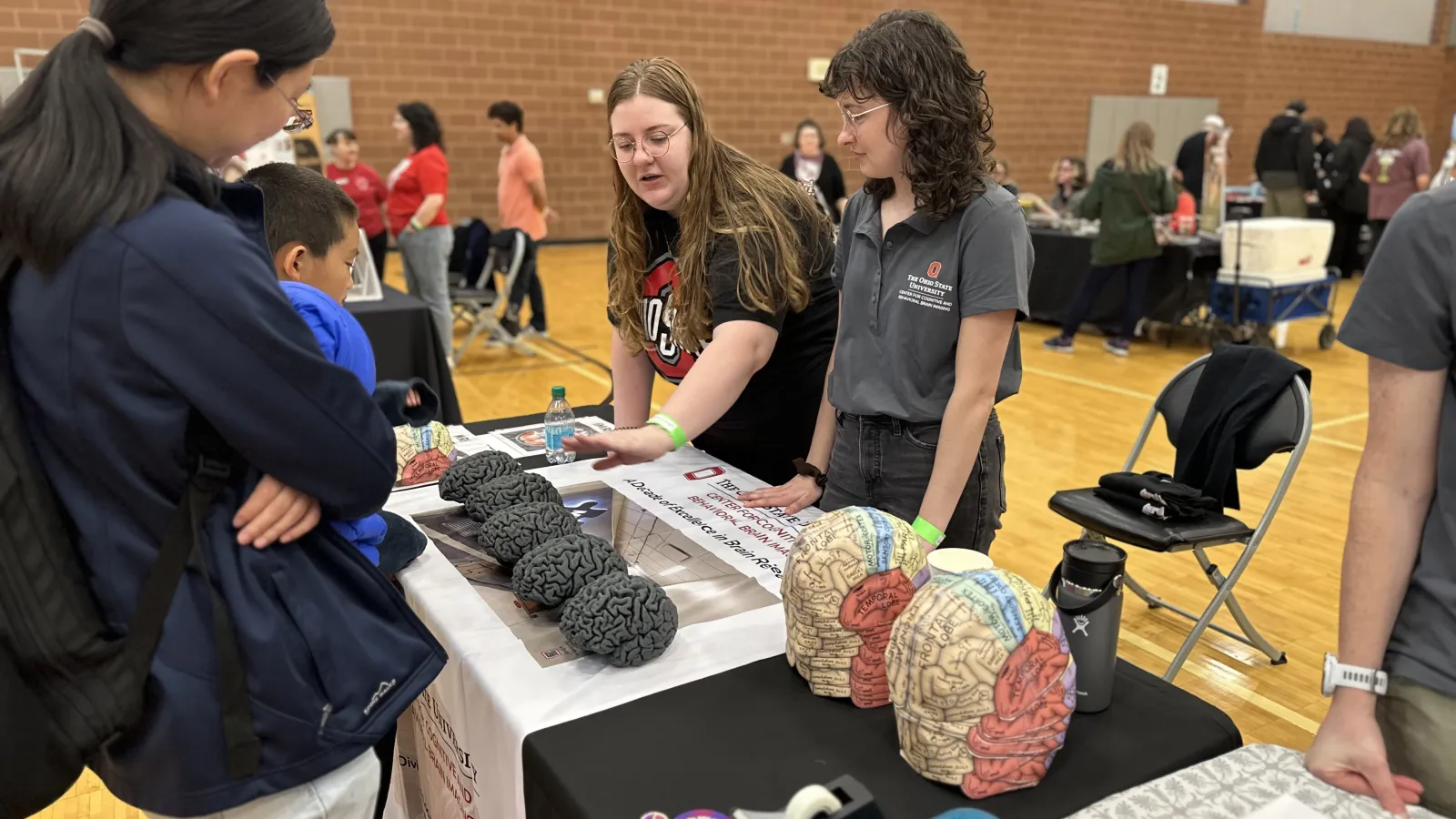 Grad students taking with visitors about the brain
